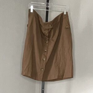 Brown skirt. Faux tortoise buttons. Pockets.
